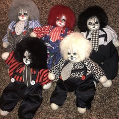 several clown dolls are sitting on the carpet