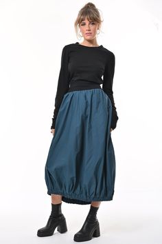 Tale: Transcend the room in your Teal Ram Parachute Skirt. This full but streamlined silhouette with gathered hem is contemporary and sleek. The large pockets are a must for all your essentials, even enough for your phone. The skirt is made from woven cotton with a contrast black rib waistband that is comfortable and creates a cinched waist. Our model is 5ft 11" and wears an S with our Beatnik Top. The skirt is 90cm from the top of the waistband to the hem, a little longer than midi...perfect to wear with boots or heels. Please see our size guide. 100% Woven Cotton, Waistband 95% Cotton 5% Elastane Made in Britain 100% Woven Cotton, Waistband 95% Cotton 5% Elastane Wash at 30* Warm Tumble Dry Warm Iron Do Not Bleach Do Not Dry Clean Parachute Skirt, Animal Print Party, Stocking Fillers For Him, Knit Loungewear, Corporate Chic, Stocking Fillers For Her, Holiday Party Outfit, Black Rib, Woven Cotton