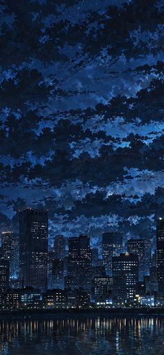 the city is lit up at night with clouds in the sky and reflecting on the water