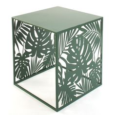 a side table made out of metal with leaves cut out on the top and bottom