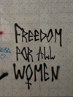 graffiti written on the wall of a women's bathroom stall reads, freedom for all women