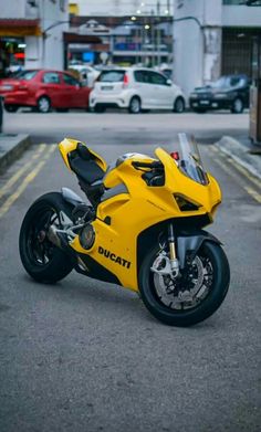 a yellow motorcycle is parked on the street