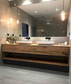 a bathroom with two sinks and a large mirror over it's counter top area