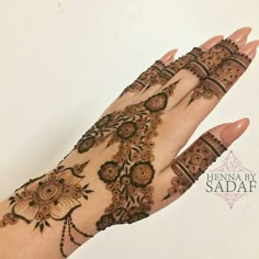 a hand with henna designs on it