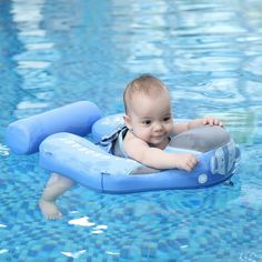 a baby sitting on an inflatable raft floating in a pool with blue water