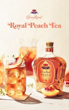 a bottle of royal peach tea next to an orange slice and some ice cubes