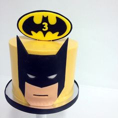 a batman cake with yellow and black frosting