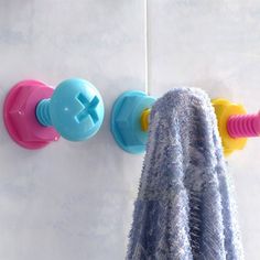 a towel is hanging on the wall next to two soap dispenser holders