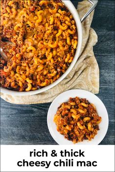 a white bowl filled with macaroni and cheese on top of a wooden table