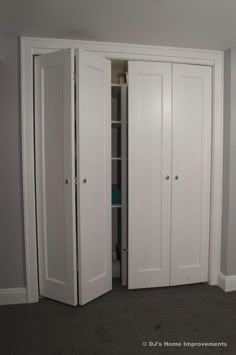 an empty room with two white closets in it