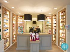 the inside of a store with shelves and lights