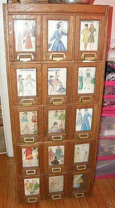 an old wooden cabinet with many pictures on it