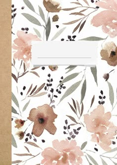 an open notebook with watercolor flowers on it and a paper label in the middle