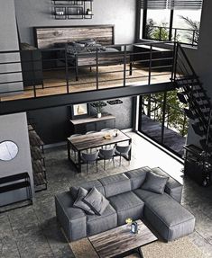 an aerial view of a living room and dining area with stairs leading up to the second floor