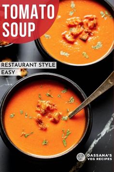 two bowls filled with tomato soup on top of a black counter next to a spoon