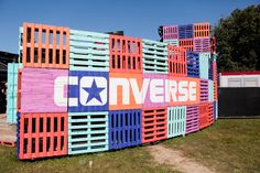 a colorful wall with the word converse painted on it's side in front of a building