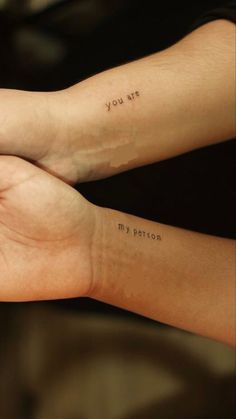 two people with tattoos on their arms that say you are my patron and i am not