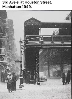 an old black and white photo of people walking in the snow