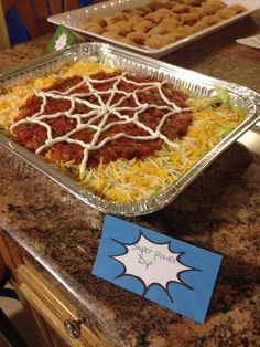 two trays of food sitting on top of a counter