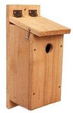 a wooden birdhouse with two holes in the roof