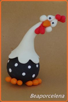 a cake shaped like a chicken with polka dots on it's head and legs