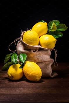 a bag full of lemons sitting on top of a wooden table