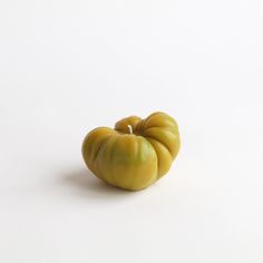 a small yellow object sitting on top of a white surface