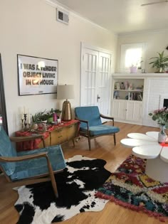 a living room filled with furniture and a fire place next to a wall mounted tv