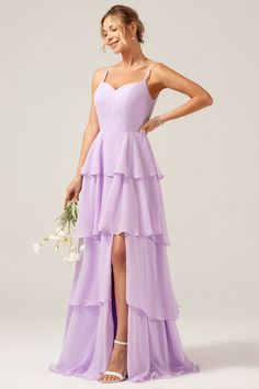 a bridesmaid in a purple dress with her legs crossed and holding a bouquet