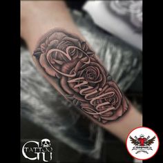 a black and grey rose with the word love tattooed on it's left arm