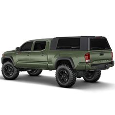 a green truck is parked on a white surface with black wheels and tires, it's all off - road