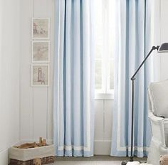 a white and blue striped curtain in the corner of a room