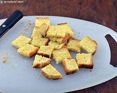 some pieces of bread on a cutting board with a knife