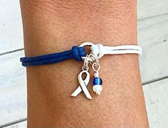 This bracelet is a great way to show your support and awareness for ALS (Amyotrophic lateral sclerosis)/Lou Gehrig's Disease. Blue and White Waxed Cotton Cord in your choice of length (please select your length from the drop-down menu).   Centerpiece is a bright silver-colored Pewter 10mm Ring.   A silver-plated Awareness Ribbon Charm and Blue/White Seed Beads are attached to the Centerpiece. A 2 1/4-inch long extension chain is attached.  Chain is Silver Plated. **To measure your wrist, place a Lou Gehrigs Disease, Als Awareness, Amyotrophic Lateral, Long Extensions, Lou Gehrig, Awareness Bracelet, Awareness Ribbon, Bracelet Ideas, Awareness Ribbons