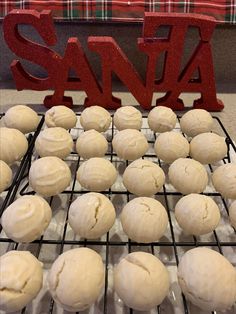 some doughnuts are cooling on a rack with the word santa spelled in red