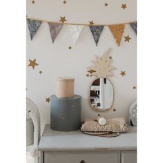 a white dresser topped with a mirror next to a wall