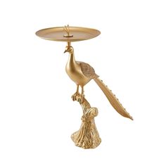 a gold plate with a bird sitting on it's leg and holding a tray