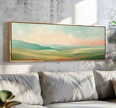 a painting hanging on the wall above a couch