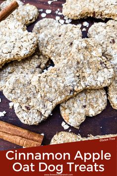 cinnamon apple oat dog treats on a wooden table with cinnamon sticks and cinnamon stick