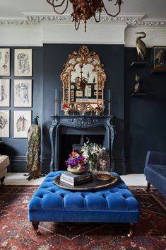 a living room with blue furniture and pictures on the wall