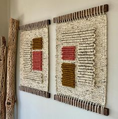 two woven wall hangings on the wall