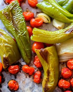 green peppers, tomatoes and other vegetables on a table