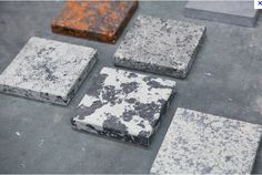 four different types of stone sitting on the ground next to each other with orange and black spots