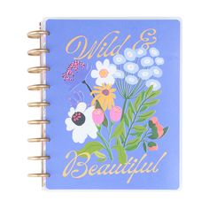 a blue notebook with flowers and bugs on it that says wild & beautiful in gold lettering