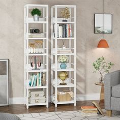 a living room with a gray couch and white bookcases in front of a beige wall