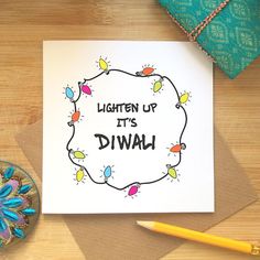 a card with the words, lighten up its diwal on it next to a bowl of pencils