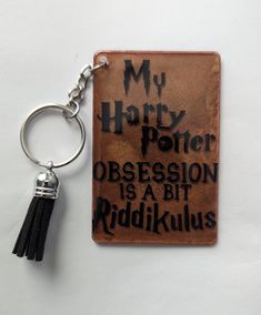 a harry potter book keychain with the words, my harry potter possession is a bit riddikkulus