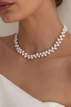 The Loraine Pearl Necklace is handcrafted with scintillating freshwater rice pearls and 14k gold filled components. 38cm/15 inches in length. Packaged in an elegant plastic-free reusable jewelry box, this necklace makes the perfect gift or special treat for oneself. 14k gold-filled chain and components Freshwater 8mm rice pearls Hypoallergenic, suitable for even the most sensitive skin Delivered in a 100% silk jewelry pouchette inside a gift box Sustainable magnetic closure jewelry box and customizable card Please note, as we use only natural pearls, shape and size may vary slightly.  We offer a one year guarantee from the date of delivery. Trendy Pearl Necklace, Pearl Jewelry Aesthetic, Jewellery For Wedding, Small Pearl Necklace, Everyday Aesthetic, Rice Pearls, Jewellery Wire, Black Dresses Classy, Silk Jewelry