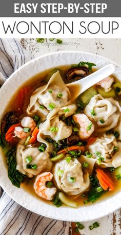 a white bowl filled with wonton soup on top of a table