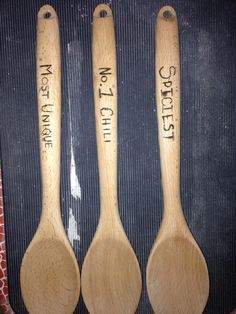 three wooden spoons with words written on them